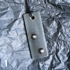 DOMINO PENDANT | steel, varnish, leather band