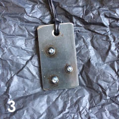 DOMINO PENDANT | steel, varnish, leather band